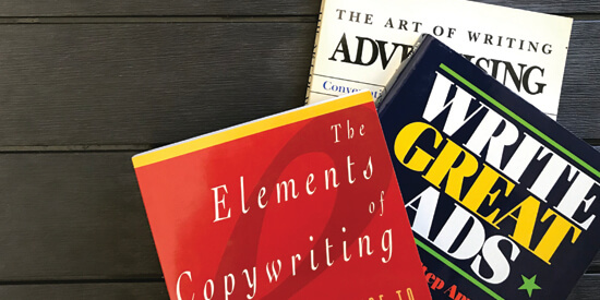 Top shot of a table featuring books on copywriting and advertising